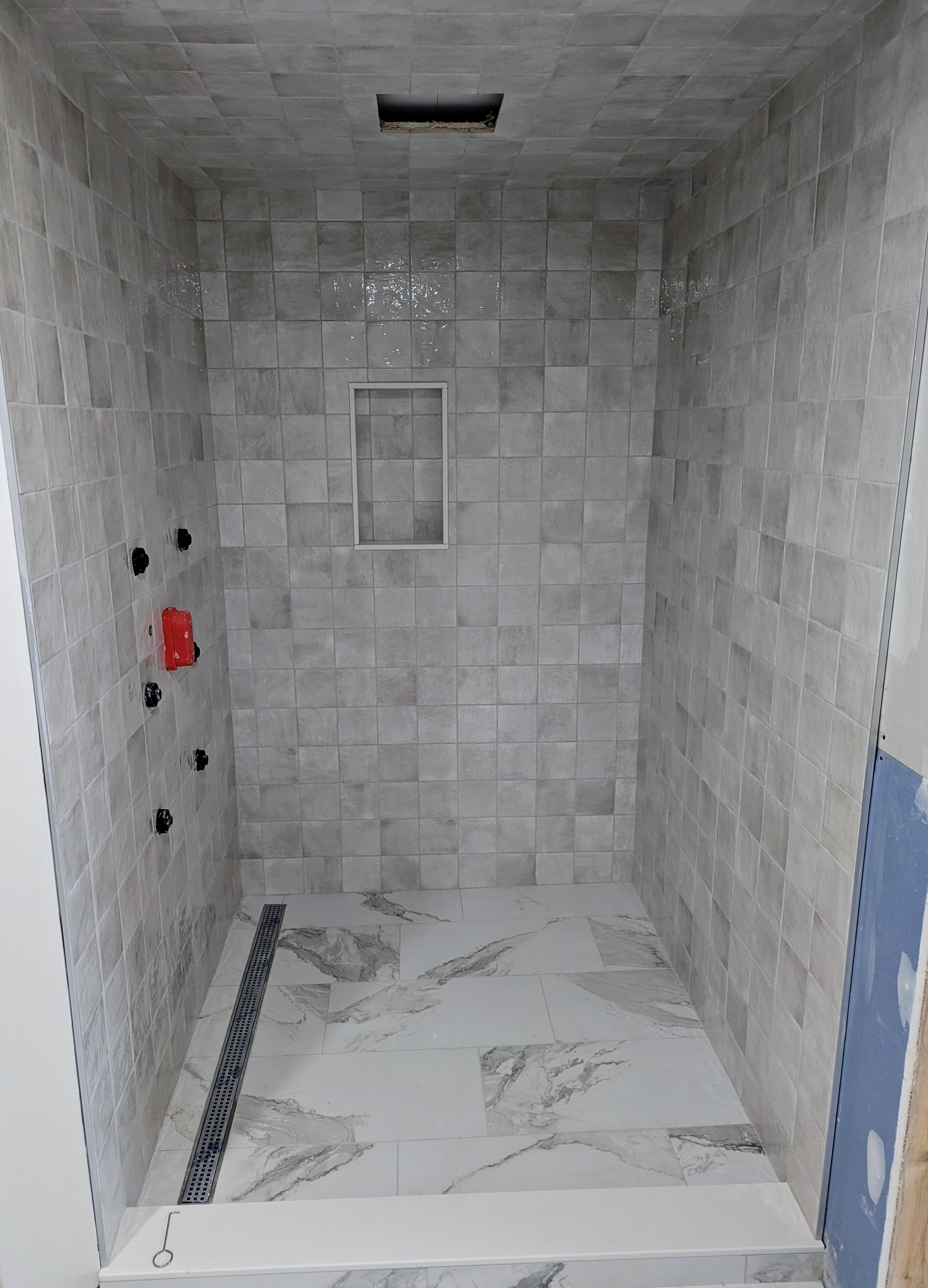 Full tile shower renovation with niche and ceiling tiles — Niagara Region