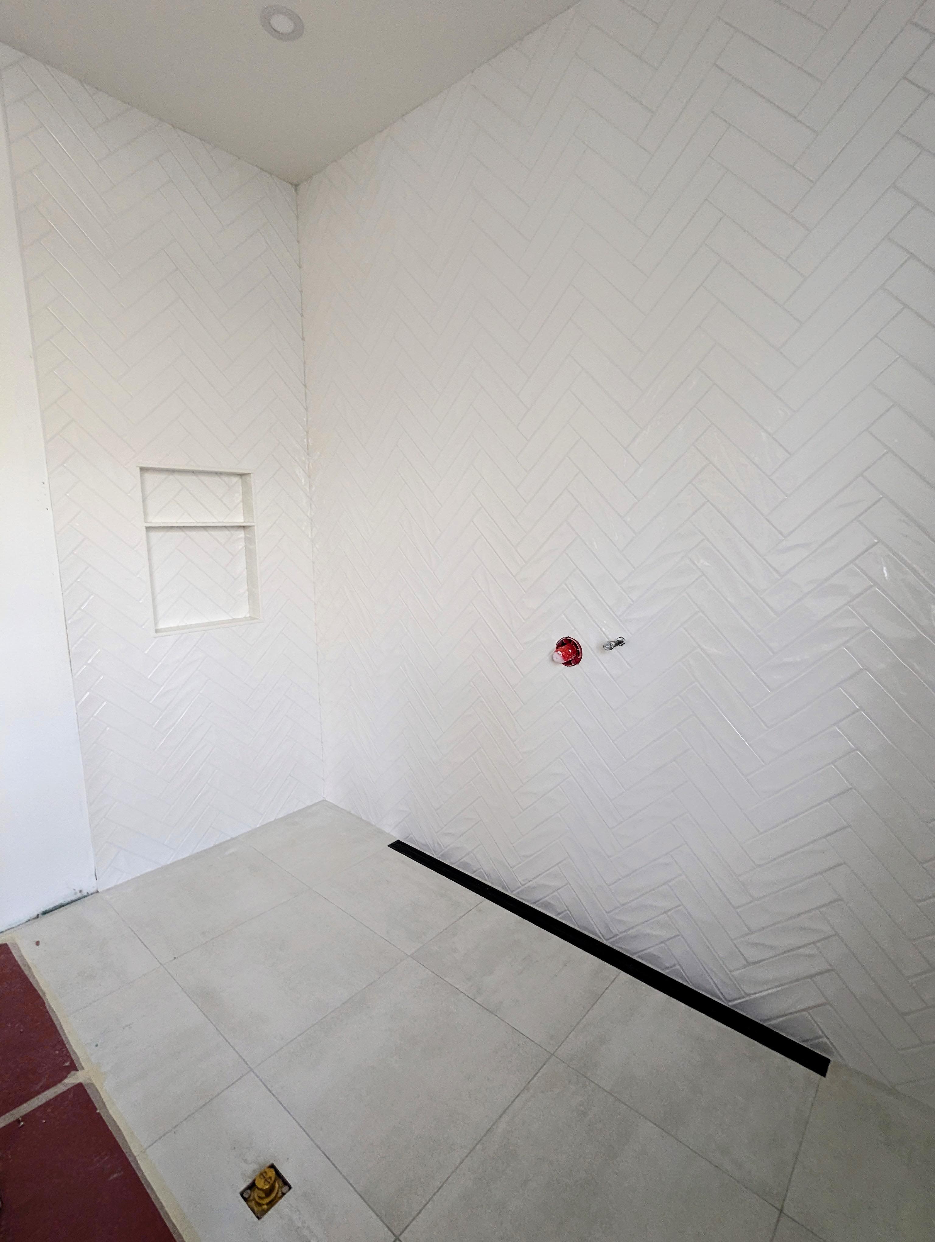 Large herringbone tile shower with linear drain — Niagara Region